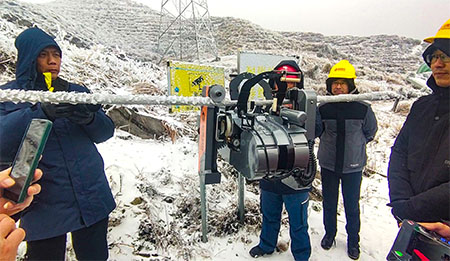 The walking wheel clicks into the guide wire and walks on the line.